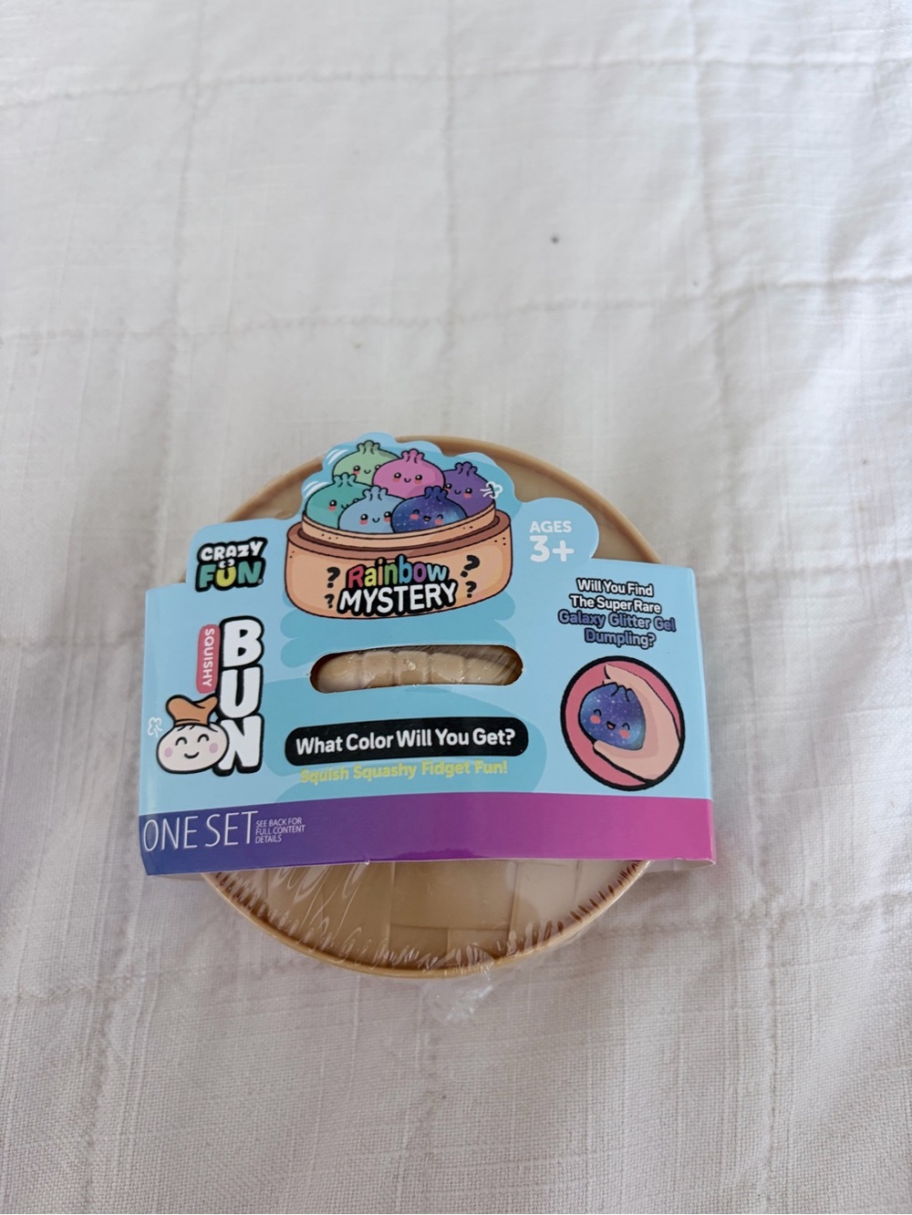 Crazy Fun Rainbow Mystery Squishy Bun Fidget Toy - Tan & Blue Packaging